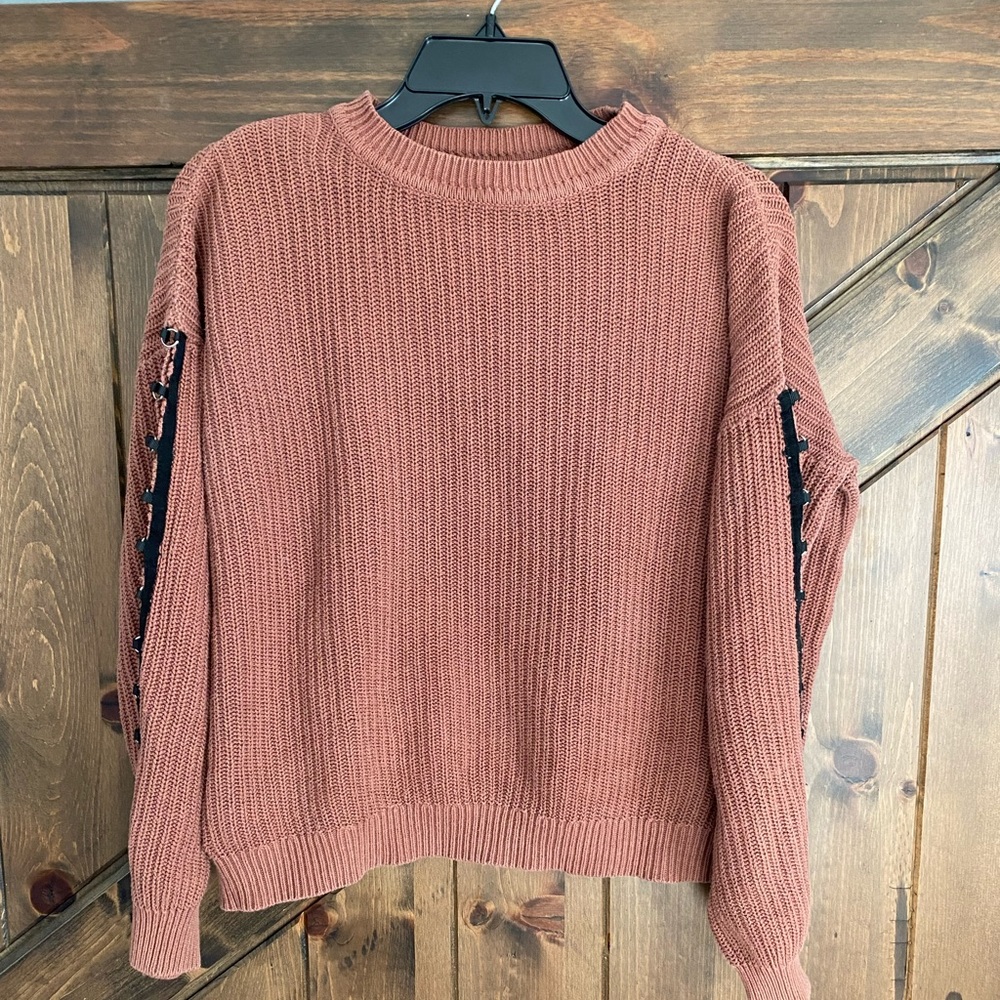 Knitted sweater with cute detailing on the side of sleeve.